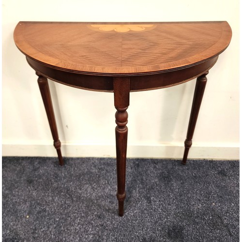 393 - MAHOGANY AND INLAID DEMI LUNE SIDE TABLE
standing on turned and tapering supports, 75cm high