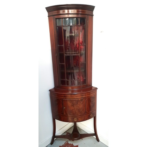 379 - 19th CENTURY MAHOGANY AND INLAID BOW FRONT FREE STANDING CORNER CABINET
with a moulded cornice above... 