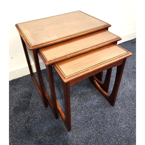 436 - NEST OF TEAK TABLES
by N.H. Chapman & Co, each with an inset glass top, standing on continuous recta... 