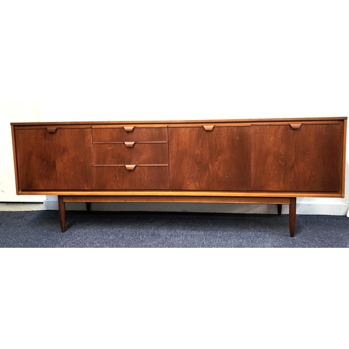 437 - AUSTIN SUITE TEAK SIDEBOARD
with three graduated drawers, a pair of cupboard doors and a pull down d... 