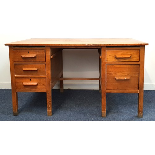 472 - 1940s OAK KNEEHOLE DESK
with an arrangement of six drawers, one now lacking, standing on plain suppo... 