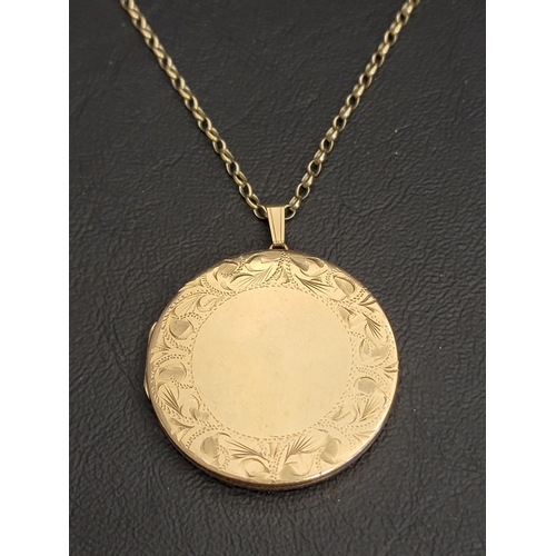 LARGE CIRCULAR NINE CARAT GOLD LOCKET PENDANT
one side with an outer ring of engraved scroll decoration, on nine carat gold belcher link chain, total weight approximately 18.3 grams