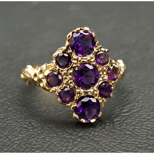 AMETHYST CLUSTER RING
with nine round cut amethyst ranging in size from approximately 0.5cts in the the centre to 0.15cts at the sides, on nine carat gold shank with decorative moulded setting and shoulders, ring size P-Q