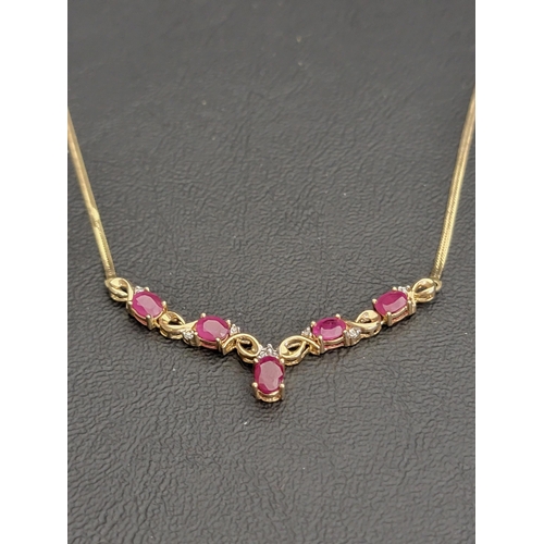104 - RUBY AND DIAMOND NECKLACE
in nine carat gold, the front pendant section set with five oval cut rubie... 