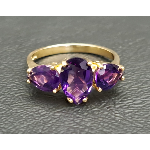 AMETHYST THREE STONE RING
the central pear cut amethyst approximately 1ct flanked by a round cut amethyst to each side, on nine carat gold shank, ring size M