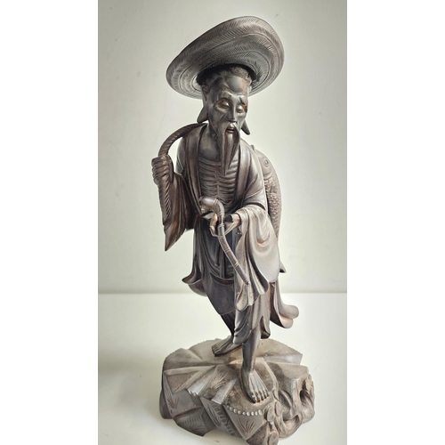 240 - EARLY 20th CENTURY CHINESE CARVED WOOD FIGURE
depicting a fisherman with a fish being carried on his... 