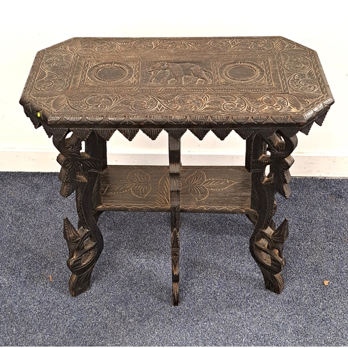 CARVED INDIAN TEAK SIDE TABLE
the shaped top decorated with a central elephant within a floral border above an inverted triangular frieze, standing on six ornate carved supports united by an undertier, 64.5cm x 69cm x 38cm