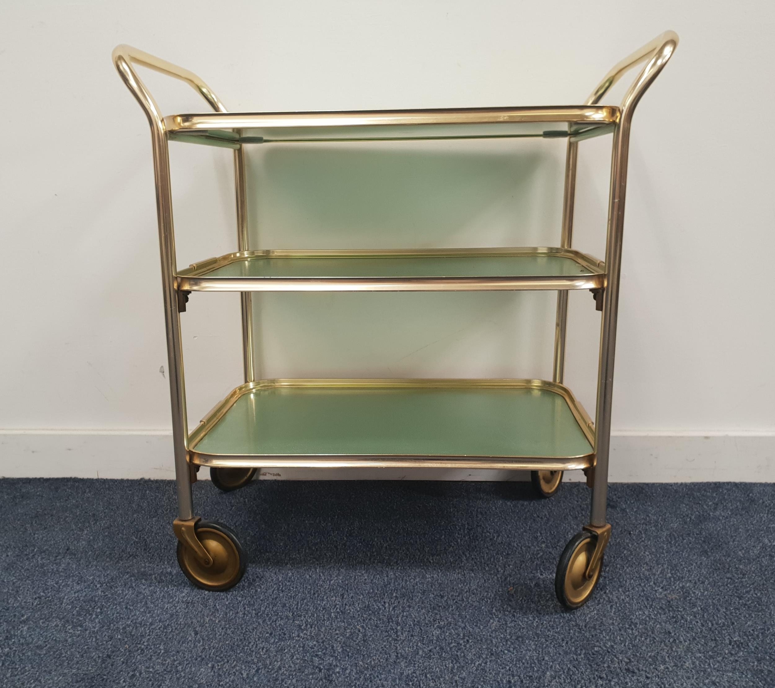 CAREFREE GILT METAL TROLLEY with three tiers, the top tier being a ...