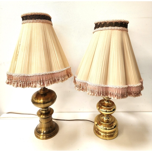 TWO BRASS TABLE LAMPS
both with turned bulbous bodies, with pleated tapering shades with tassels, 79cm and 83cm high (2)