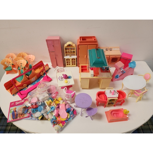 LARGE SELECTION OF BARBIE FURNITURE AND HOUSEHOLD ACCESSORIES
including a battery operated washer/dryer, a kitchen unit with hob, oven and sink, an exercise bike and sports locker, a wardrobe, a side cabinet, bathroom fittings, tables chairs, crockery, ornaments, etc.; together with a Golden Sound Story Barbie Birthday Surprise for Skipper book, Barbie Hawaiian Holiday book; and a Sindy Magic Dreamboat