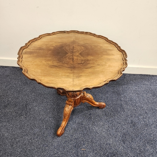 423 - WALNUT OCCASIONAL TABLE
with a circular pie crust top, standing on a turned column and tripod base, ... 