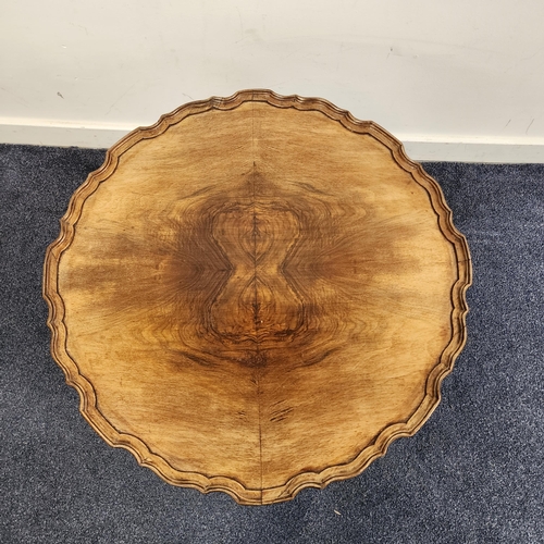 423 - WALNUT OCCASIONAL TABLE
with a circular pie crust top, standing on a turned column and tripod base, ... 