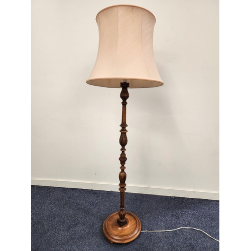 CARVED STANDARD LAMP
raised on a circular base with a turned column and pale pink shaped shade, 170cm high