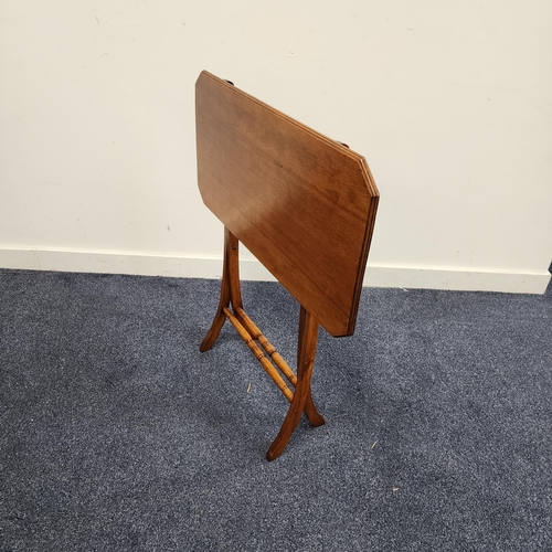 425 - MAHOGANY COACHING TABLE
with a rectangular top with canted corners on a folding X frame with turned ... 