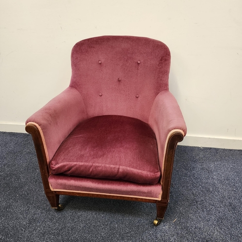 VICTORIAN MAHOGANY ARMCHAIR
with a button back and loose seat cushion, standing on tapering front supports with brass casters