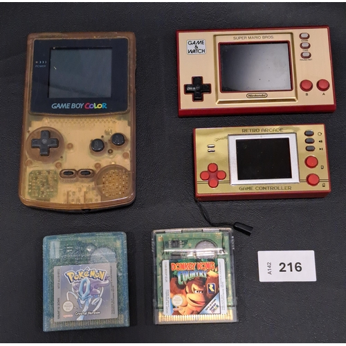 TWO NINTENDO GAMES CONSOLS
comprising a Game Boy Color including 2 games, Pokémon crystal version and Donkey Kong country; a Game & Watch Super Mario Bros; and a retro arcade console. (3)
Note: Game Boy Color is missing battery cover