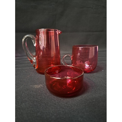 192 - SELECTION OF CRANBERRY AND RUBY GLASS
comprising a pair of salts, small jug, frill rim squat vase, i... 