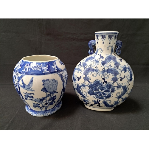 CHINESE BLUE AND WHITE MOON FLASK
with a flared neck flanked by shaped handles, the body decorated with feathers, 28cm high, together with a Chinese blue and white lobed tapering vase decorated with panels of flowers and birds, 19.5cm high (2)