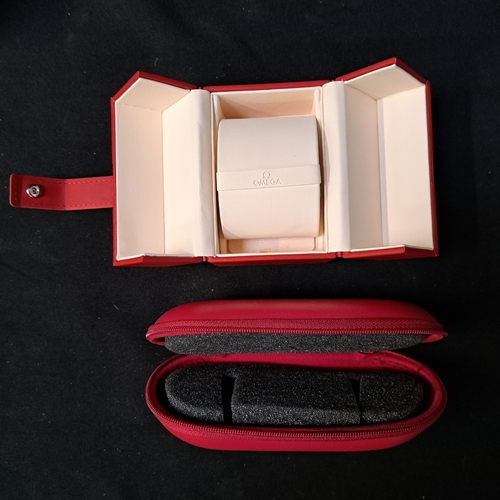 156 - OMEGA RED LEATHERETTE WATCH BOX
with a branded fold over closure strap, double flap opening lid with... 