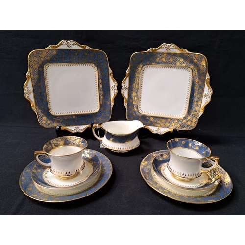 PARAGON TEA SET
decorated with a white ground with a blue border with gilt floral highlights, comprising eleven cups, twelve saucers, eleven side plates, milk jug, cake and sandwich plate (37)