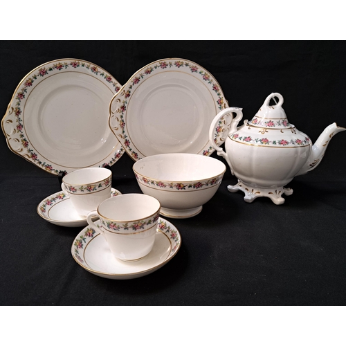 PORCELAIN TEA SET
decorated with a floral border with gilt highlights on a white ground, comprising eleven cups, twelve saucers, cake and sandwich plate, tea bowl and lidded tea pot (28)