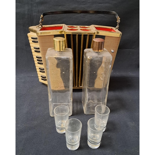 262 - NOVELTY MUSICAL ACCORDIAN DECANTER SET
with two decanters and four shot glasses, with a fold over ca... 