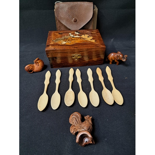 MIXED LOT OF COLLECTABLES
comprising an Indian teak inlaid box, seven shaped bone spoons, carved elephant and two cockerel netsuke and a leather wallet containing vintage fishing flies