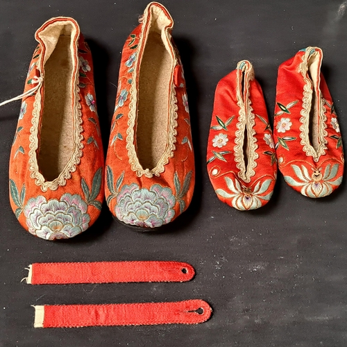 PAIR OF CHINESE RED SILK SLIPPERS
decorated with floral motifs, together with a pair of children's red silk slippers decorated with floral motifs (2 pairs)