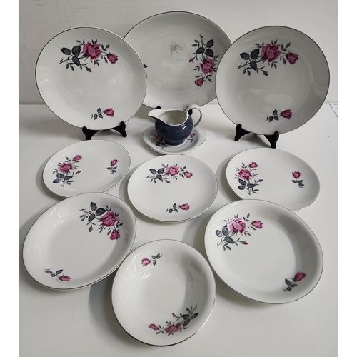 BURLEIGH WARE DINNER SERVICE
decorated with roses on a white ground with silver highlights, comprising five soup bowls, six dinner plates, six side plates, six dessert bowls, oval meat plate, sauce boat and saucer (26)