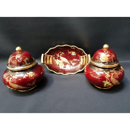 CARLTON WARE ROUGE ROYALE
comprising a boat shaped pin dish and a pair of lidded jars (3)