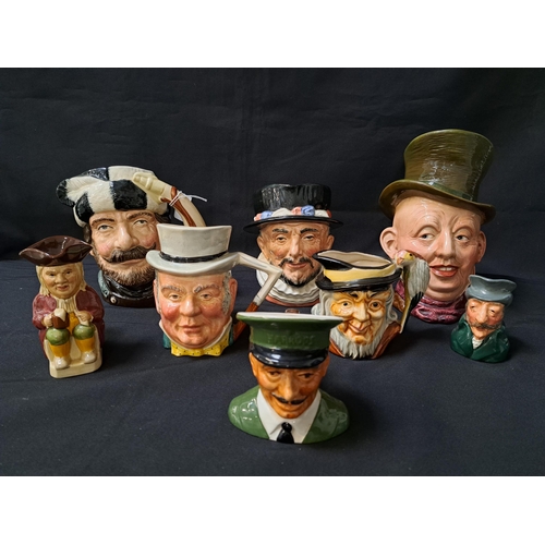 EIGHT CHARACTER JUGS
comprising two Royal Doulton - Trapper, 19cm high and Beefeater, 16.5cm high; Beswick Micawber, 23cm high; Sandland Mr. John Bull, 13.5cm high; Man and bird, 11cm high; Carlton Ware Harrods door man, 10.5cm high; Wood & Sons Toby jug, 12.5cm hig; and a Kelsbro Ware The Colonel, 9cm high (8)