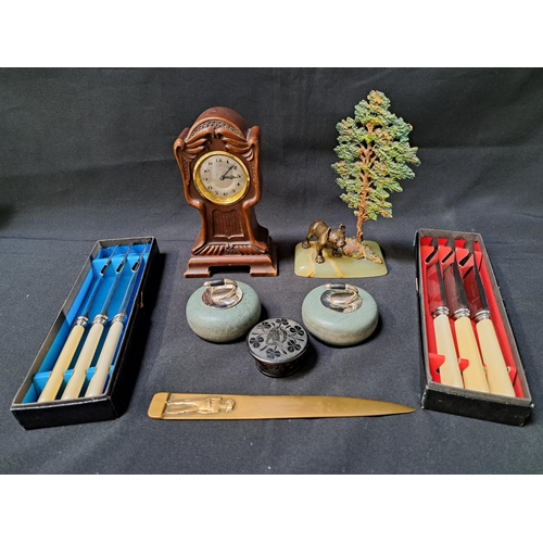 MIXED LOT OF COLLECTABLES
comprising a pair of desk ornament curling stones, letter opener, set of six boxed table knives, miniature longcase clock time piece, carved Irish circular box and an onyx and spelter desk ornament