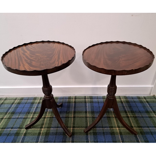 PAIR OF OVAL MAHOGANY WINE TABLES
with scalloped edges, on a turned column and tripod base, 56cm high (2)