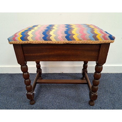 MAHOGANY PIANO STOOL
with a padded lift up seat, on bobbin turned supports united by a stretcher, 55cm x 54cm x 38cm