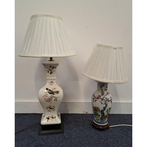 POTTERY BALUSTER LAMP
decorated with birds and foliage, with a pleated white shade, 61cm high, together with a Chinese style lamp decorated with cherry blossom and flowers, with a pleated white shade, 48cm high (2)