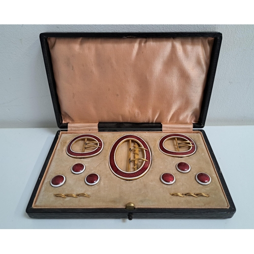 LADIES ENAMEL AND GILT DRESS SET
comprising three oval buckles and six circular buttons, all in red and white enamel, in a fitted case