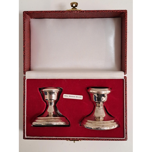 PAIR OF ELIZABETH II SILVER CANDLESTICKS
of stout form raised on circular loaded bases, in a fitted case, Birmingham 1997