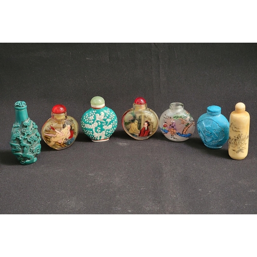 SEVEN CHINESE SNUFF BOTTLES
comprising a green ground example decorated with birds in a tree, with a green agate stopper, 6cm high, a cylindrical bone example decorated with figures and a prawn, with stopper, 7cm high, two reverse glass painted examples with erotic scenes, 6cm high, a glass reverse painted example with a scholar and student, lacking stopper, 5cm high, and two relief carved examples with stoppers, 8cm and 5.5cm high (7)