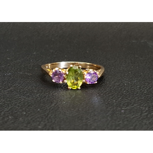 PERIDOT AND AMETHYST THREE STONE RING
the central oval cut peridot approximately 0.75cts flanked by round cut amethysts, on nine carat gold shank, ring size O