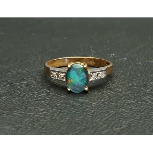 OPAL TRIPLET AND DIAMOND DRESS RING 
the central oval cabochon opal triplet measuring approximately 7.8mm x 5.9mm, flanked by two diamonds to each shoulder, on a nine carat gold shank, ring size O
