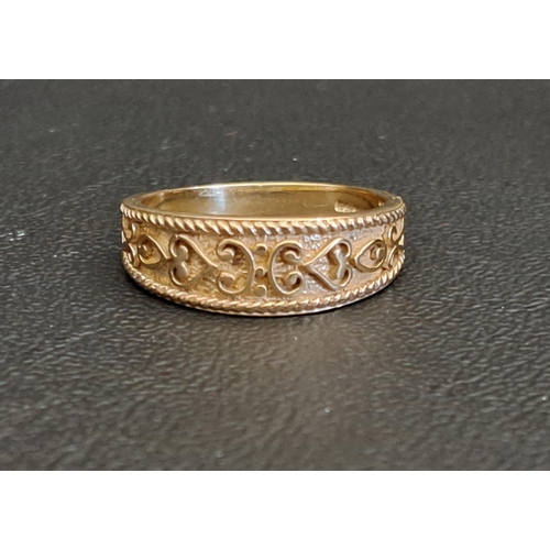 ATTRACTIVE NINE CARAT GOLD BAND
with relief scroll decoration, ring size P-Q and approximately 3.4 grams