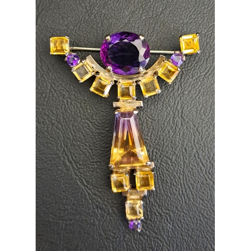 UNUSUAL GEM SET BROOCH
the central ametrine with citrines and amethysts above and below in shaped unmarked silver setting, 5.9cm high