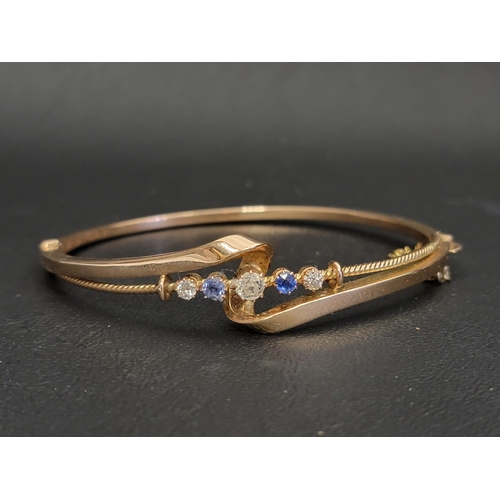 EARLY 20th CENTURY DIAMOND AND SAPPHIRE SET BANGLE
the five graduated gemstones in attractive twist setting, the diamond totalling approximately 0.45cts and the sapphires approximately 0.2cts, in unmarked gold (tests as 14/15 carat), approximately 11.3 grams