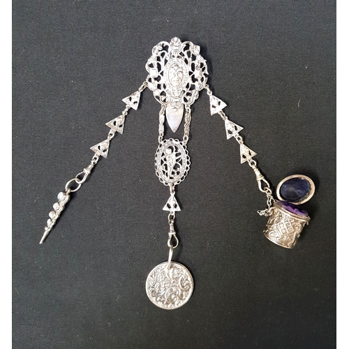 VICTORIAN SILVER CHATELAINE
the clip with pierced decoration around a central mask, Birmingham 1887, with a propelling pencil with agate decoration, Birmingham 1891, a velvet lined thimble case, Birmingham 1899 and a double sided circular disks pin cushion, now lacking wadding, Birmingham 1899, 62g/2.18oz
