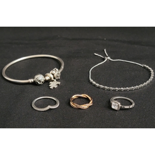 SELECTION OF FASHION JEWELLERY
comprising a Pandora silver bangle with two charms, three Pandora rings - Sparkling Wishbone, Square Sparkle Halo ring and a rose gold plated Twisted Lines ring; and a Swarovski slider bracelet
