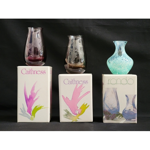 256 - THREE BOXED CAITHNESS VASES
including a Rondo bud vase in amethyst and etched with a merry-go-round ... 