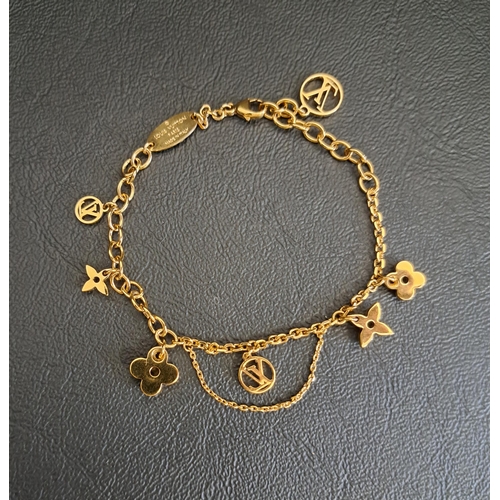 8 - LOUIS VUITTON BLOOMING SUPPLE BRAELET
in gold tone with LV circle and monogram flower charms