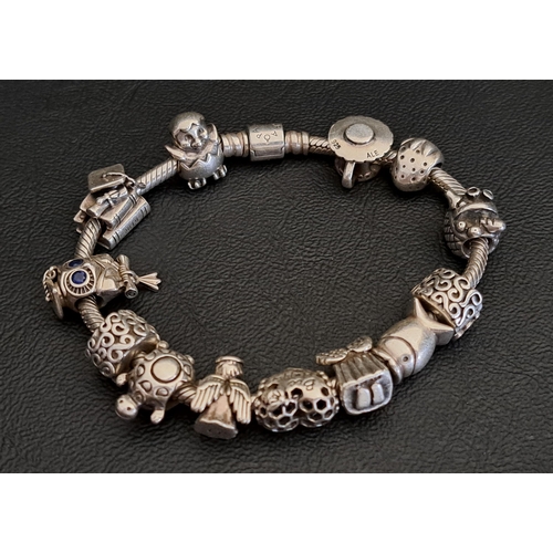 PANDORA MOMENTS SILVER BARREL CLASP SNAKE CHAIN BRACELET
complete with eleven Pandora charms including an owl, a graduation cap and books, a turtle and and a fish; and two Pandora clips