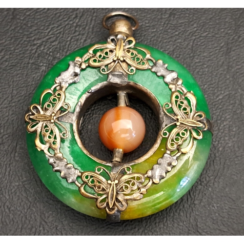 UNUSUAL CHINESE JADE PENDANT
the green jade ring with white metal butterfly decoration and a central agate bead, 5cm wide and approximately 58 grams