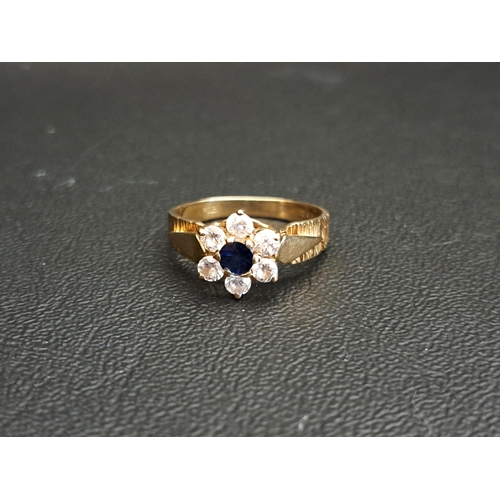 SAPPHIRE AND CZ CLUSTER RING
the central round cut sapphire in six CZ surround, on nine carat gold shank with textured detail to the shoulders, ring size P and approximately 3cts